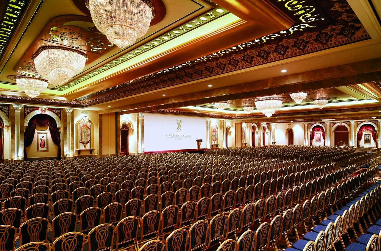Mardan Palace — Conference hall with rows of chairs and a gilded ceiling