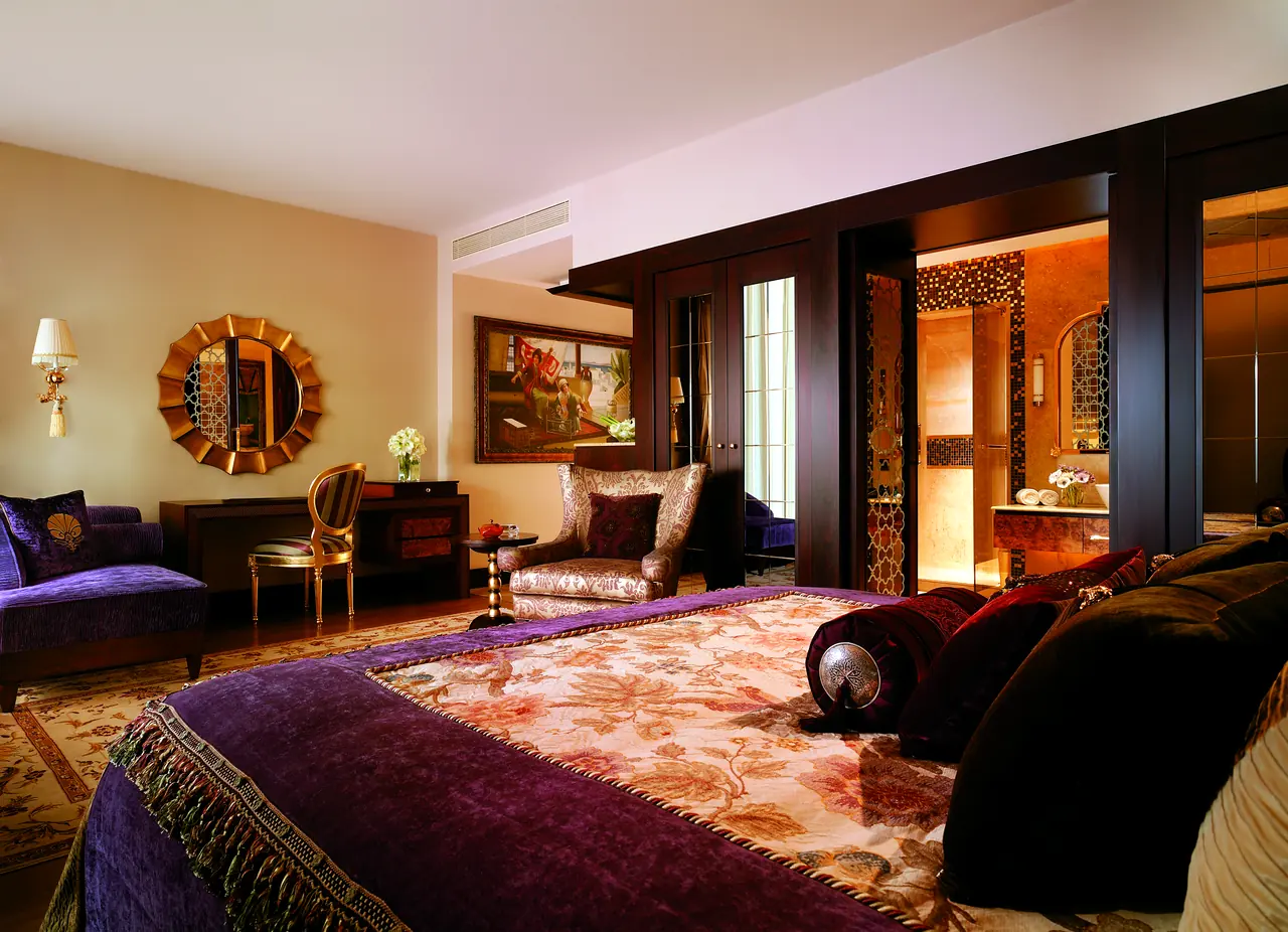 Mardan Palace — Bedroom with embroidered cover and sunburst mirror