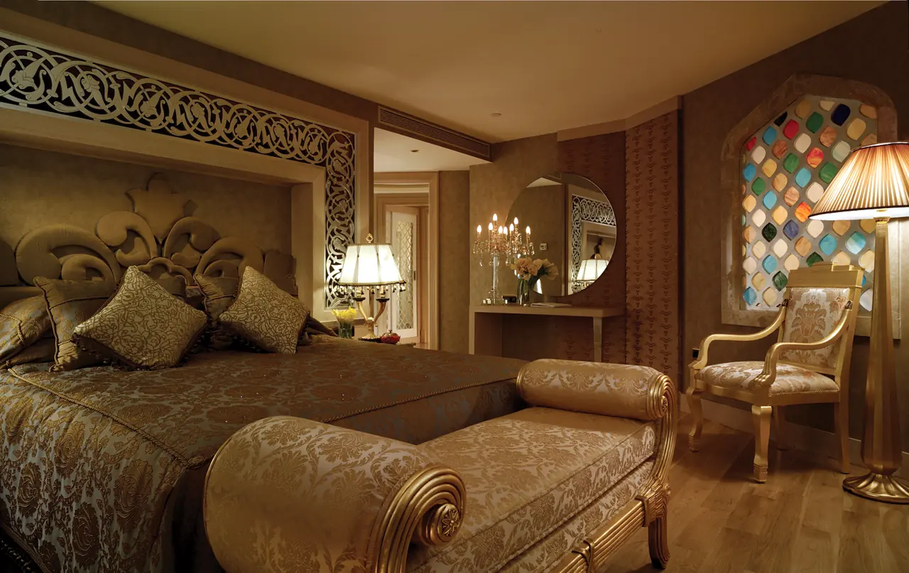 Mardan Palace — Bedroom with carved headboard and coloured-glass window