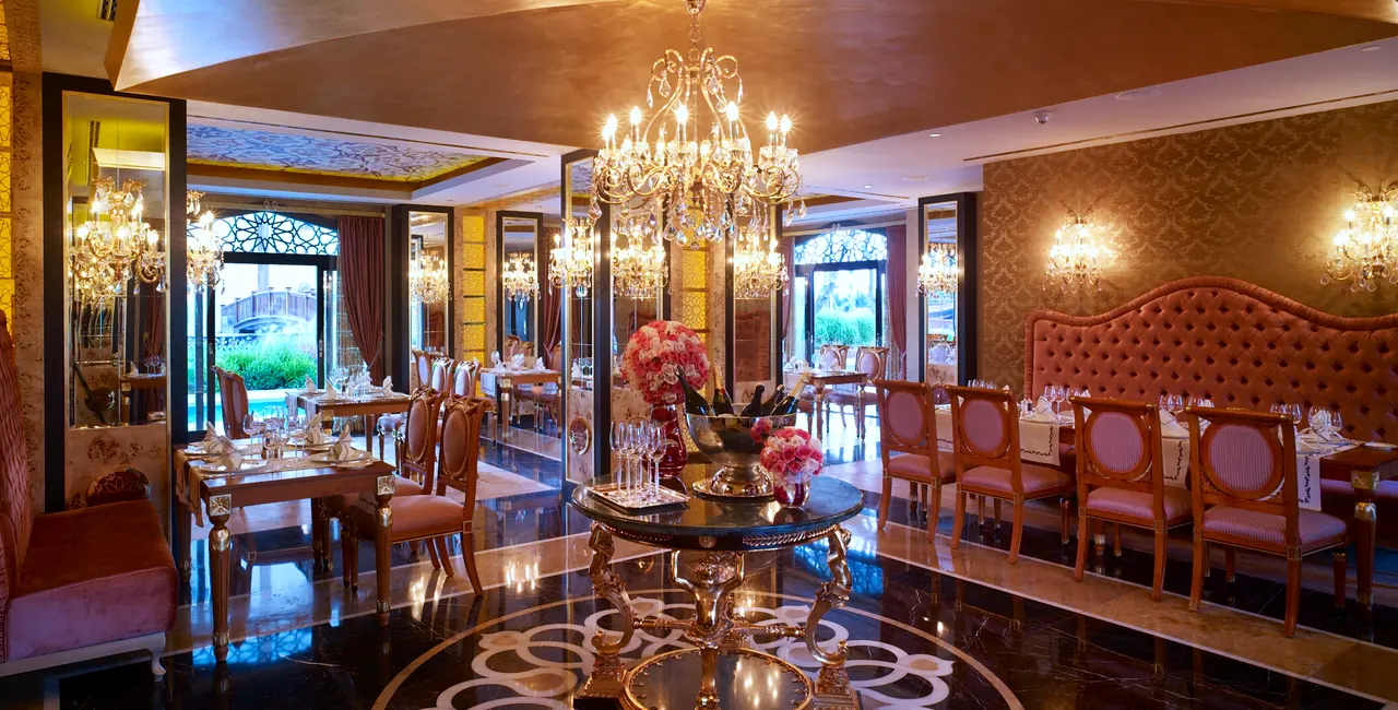 Mardan Palace — Restaurant with crystal chandeliers, tufted banquette and inlaid floor