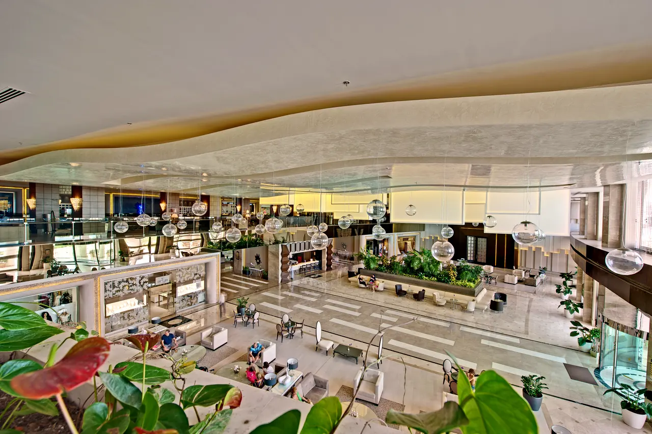 Maxx Royal Belek — View from the gallery level down to a planted lobby