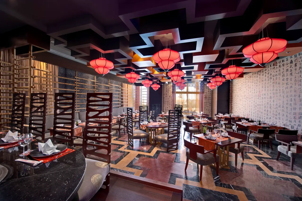 Maxx Royal Belek — Restaurant with red lanterns and a geometric ceiling