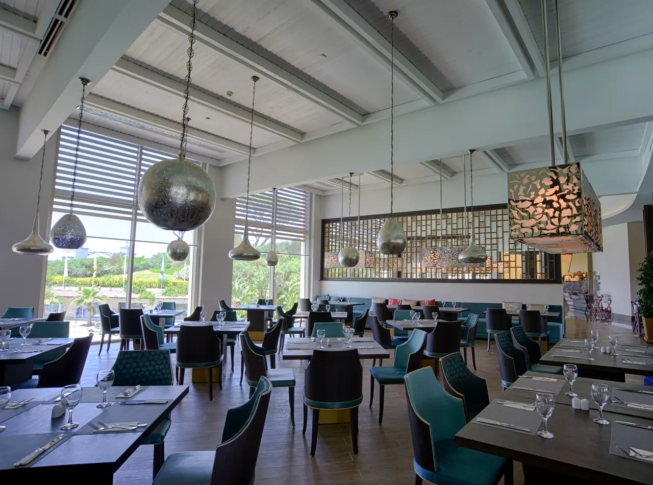 Rixos Premium Belek — Restaurant with metal pendants and garden view