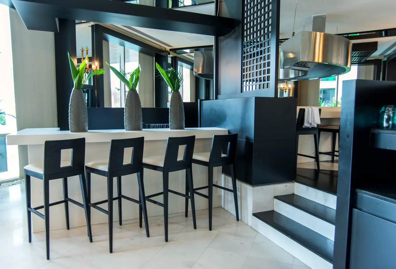 Rixos Premium Belek — Bar with white counter and black stools