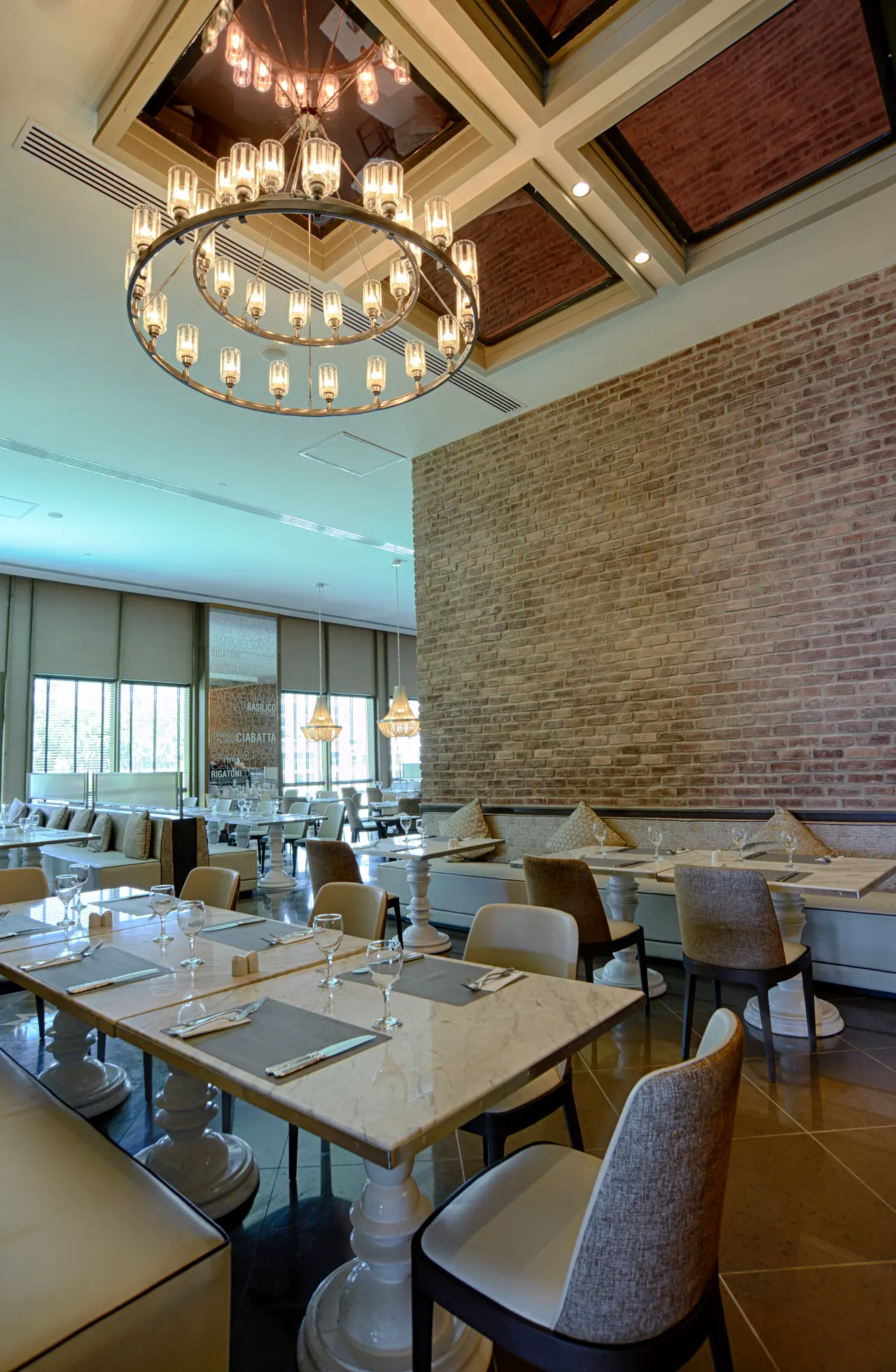 Rixos Premium Belek — Restaurant with brick wall and chandelier